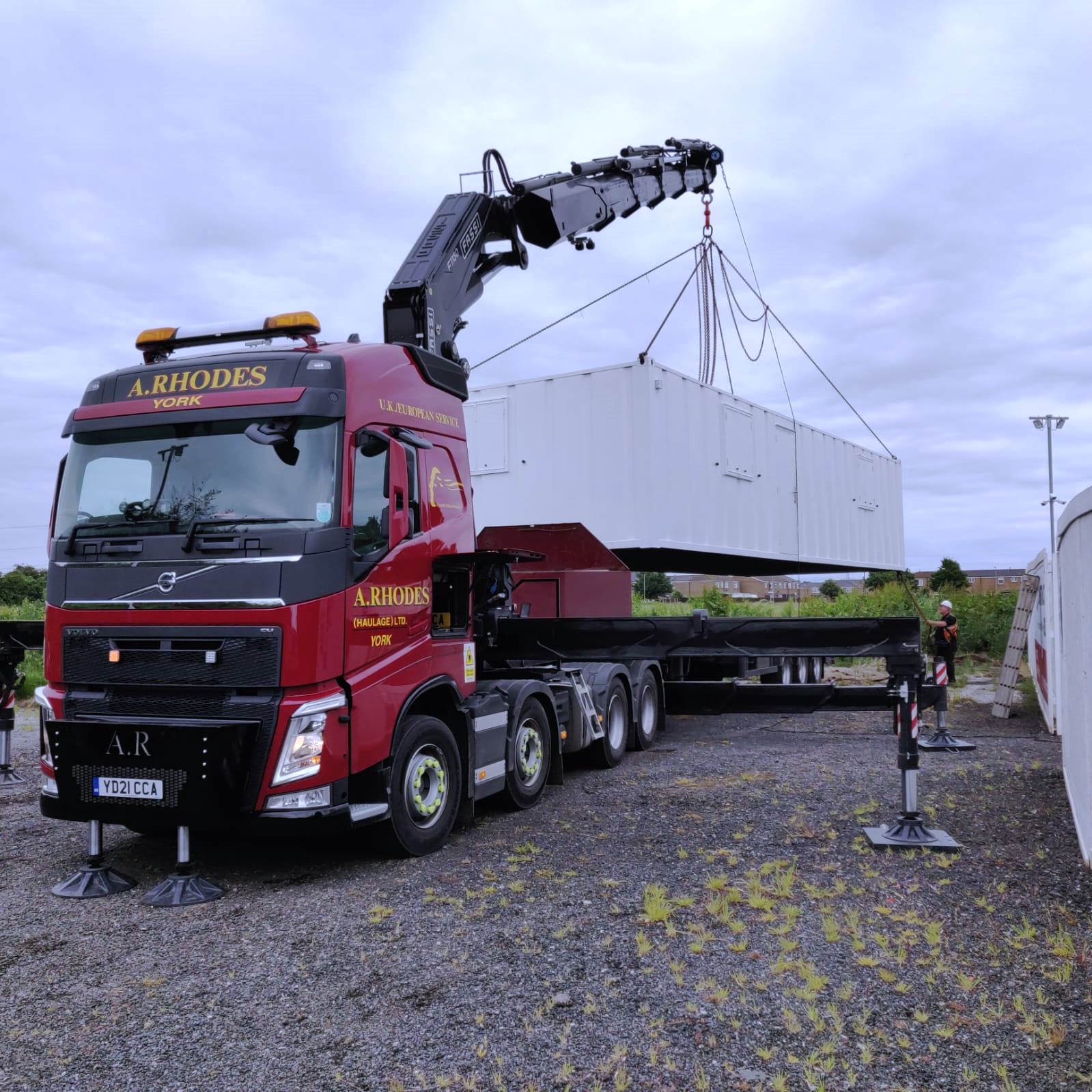 red truck delivering a portable cain to a construction site